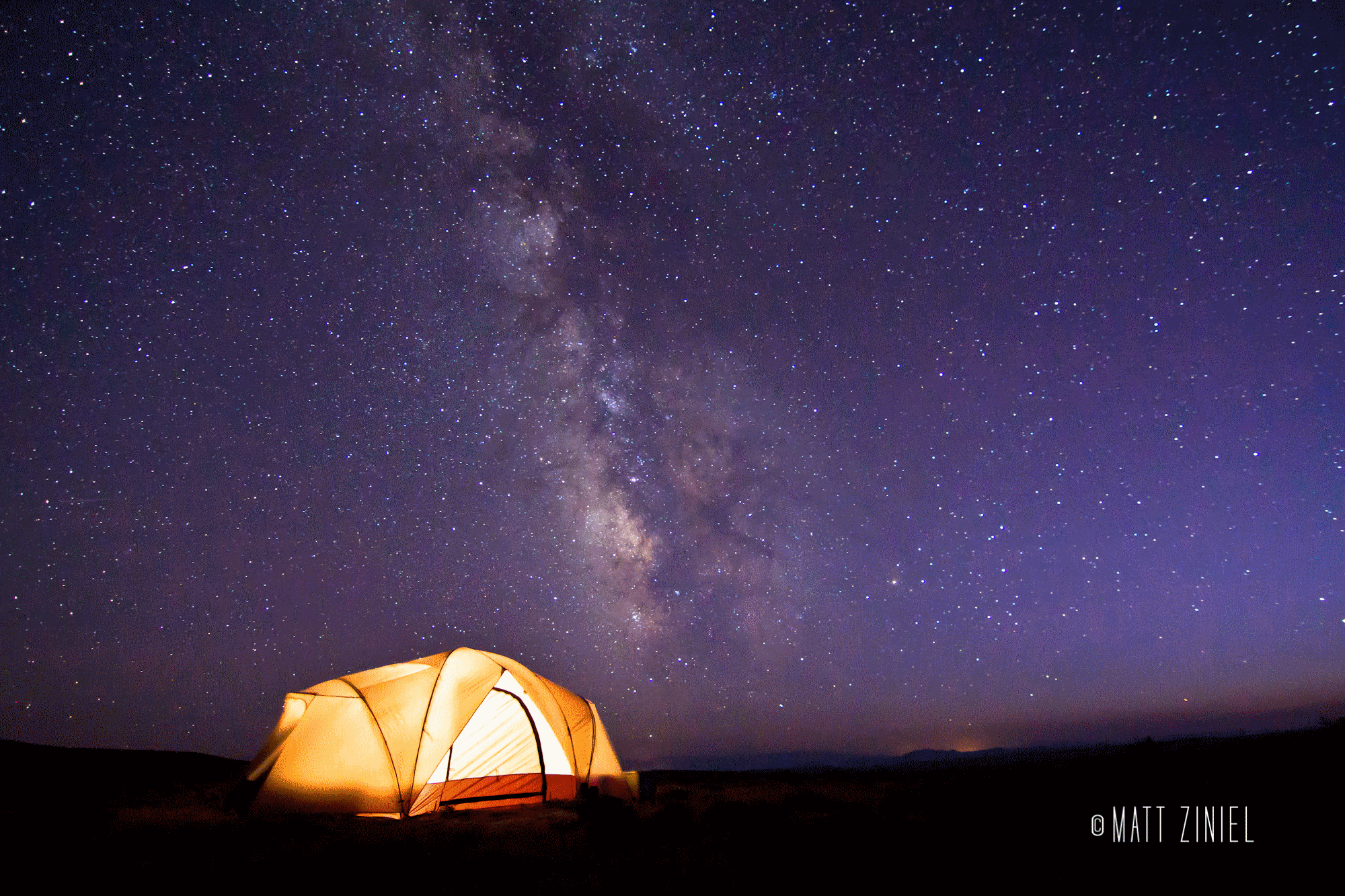 Camping out under the Milky Way in central Wyoming, by photographer Matt Ziniel. 